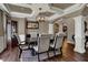 Elegant dining room features coffered ceiling, hardwood floors, and a spacious dining table at 13934 Salsbury Creek Dr, Carmel, IN 46032