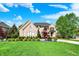 Brick home with a green lawn and landscaping at 13934 Salsbury Creek Dr, Carmel, IN 46032