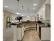 Basement kitchen with granite countertops, updated appliances, and decorative lighting at 13934 Salsbury Creek Dr, Carmel, IN 46032