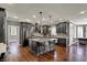 Modern kitchen with grey cabinets, stainless steel appliances, and a large center island with seating at 13934 Salsbury Creek Dr, Carmel, IN 46032
