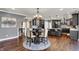 Open-concept view of kitchen and dining area with dark hardwood floors and stainless steel appliances at 13934 Salsbury Creek Dr, Carmel, IN 46032