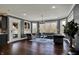 Comfortable living room featuring hardwood floors, large windows, and plenty of seating at 13934 Salsbury Creek Dr, Carmel, IN 46032