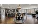 Open-concept living and dining areas with dark hardwood floors, grey accents and lots of natural light at 13934 Salsbury Creek Dr, Carmel, IN 46032