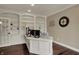 Bright office features built-in bookshelves, hardwood floors, and a desk with ample workspace at 13934 Salsbury Creek Dr, Carmel, IN 46032