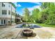 An in-ground pool sits in the backyard next to a patio with a fire pit, creating an outdoor oasis perfect for relaxation and entertainment at 13934 Salsbury Creek Dr, Carmel, IN 46032