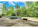 Inviting backyard pool area with mature trees surrounding the property offers a serene and private outdoor retreat at 13934 Salsbury Creek Dr, Carmel, IN 46032