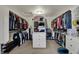Spacious walk-in closet featuring custom shelving, storage, and a central drawer unit at 13934 Salsbury Creek Dr, Carmel, IN 46032