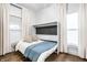 Open Murphy bed with bedding, pillows, and a blue throw blanket in bedroom at 1451 N Grant Ave, Indianapolis, IN 46201