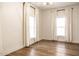Bright bedroom with hardwood floors and large windows at 1451 N Grant Ave, Indianapolis, IN 46201