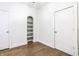 Bedroom features hardwood floors, a charming bookshelf nook, and neutral paint at 1451 N Grant Ave, Indianapolis, IN 46201