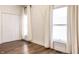 Bright bedroom with hardwood floors, closet and natural light from the two windows at 1451 N Grant Ave, Indianapolis, IN 46201
