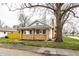 Charming brick home with a cozy front porch and well-maintained lawn at 1451 N Grant Ave, Indianapolis, IN 46201