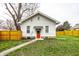 Charming front exterior of a white house with a red door, sidewalk, and green lawn at 1451 N Grant Ave, Indianapolis, IN 46201