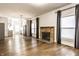 Spacious living room with hardwood floors, a fireplace, and kitchen view at 1451 N Grant Ave, Indianapolis, IN 46201