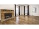 Open living room featuring beautiful hardwood floors and a brick fireplace at 1451 N Grant Ave, Indianapolis, IN 46201