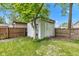 View of the backyard featuring a grassy lawn, wooden fence and a small storage shed at 1508 Monument St, Noblesville, IN 46060