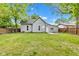 Exterior back of house with a spacious backyard lawn and trees at 1508 Monument St, Noblesville, IN 46060