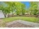 View of the backyard featuring a grassy lawn and wooden fence from the back of the dilapidated deck at 1508 Monument St, Noblesville, IN 46060