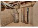 Basement water heater with cement block walls and overhead piping at 1508 Monument St, Noblesville, IN 46060