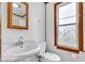 Bathroom featuring a wood framed mirror and frosted window at 1508 Monument St, Noblesville, IN 46060
