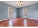 Spacious bedroom with hardwood floors and natural light from two windows at 1508 Monument St, Noblesville, IN 46060