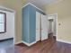 Hallway featuring multiple doorways, laminate flooring, and neutrally painted walls for customization at 1508 Monument St, Noblesville, IN 46060