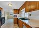 Spacious kitchen with views to another room and natural light coming from the window at 1508 Monument St, Noblesville, IN 46060