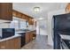 Well-lit kitchen with wood cabinets and an adjacent room at 1508 Monument St, Noblesville, IN 46060