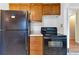 Full kitchen with refrigerator and oven next to wood cabinets at 1508 Monument St, Noblesville, IN 46060