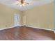 Living room with hardwood floors, featuring a ceiling fan and a classic front door at 1508 Monument St, Noblesville, IN 46060