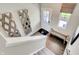 Bright entryway with modern mirrors, wood-look flooring, bench seating, and natural light at 15275 Farrington Way, Fishers, IN 46037
