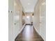 Spacious hallway with wood-look floors, white trim, and leading to the home's entryway at 15275 Farrington Way, Fishers, IN 46037
