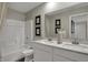 Elegant bathroom with double sink vanity, framed mirrors, and tub shower at 15334 Swallow Falls Way, Fishers, IN 46037