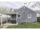 Exterior showing the house with AC unit, covered porch, and a spacious backyard at 1643 E Tabor St, Indianapolis, IN 46203