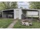 Carport with car, storage shed, fire pit, and a fenced backyard at 1643 E Tabor St, Indianapolis, IN 46203
