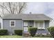 Charming single-story home with gray siding, trimmed hedges, and a well-maintained front yard at 1643 E Tabor St, Indianapolis, IN 46203
