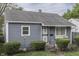 Quaint one-story home with gray siding, trimmed bushes, and 'Welcome' decor at 1643 E Tabor St, Indianapolis, IN 46203