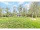 Lush green backyard featuring mature trees, offering shade and privacy for outdoor relaxation at 192 Lynnette Way, Cumberland, IN 46229