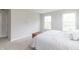 Sunlit bedroom featuring neutral walls, plush carpet, and a wooden storage chest at 192 Lynnette Way, Cumberland, IN 46229