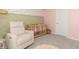 Charming Bedroom showcasing a crib, a beige armchair, and a patterned accent wall at 192 Lynnette Way, Cumberland, IN 46229