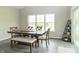 Bright dining room with natural light and a large wooden table with seating for six at 192 Lynnette Way, Cumberland, IN 46229