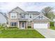 Charming two-story home with a well-manicured lawn and attached two car garage at 192 Lynnette Way, Cumberland, IN 46229