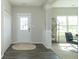 Welcoming foyer with wood floors, decorative column, coat closet and natural light at 192 Lynnette Way, Cumberland, IN 46229