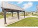 Community gazebo features covered seating with sidewalks and landscaped yard at 192 Lynnette Way, Cumberland, IN 46229
