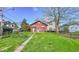 View of the backyard of the red house from the far side of the yard at 21 N Bosart Ave, Indianapolis, IN 46201