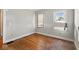 Modest bedroom with hardwood floors and two windows for natural light at 21 N Bosart Ave, Indianapolis, IN 46201