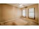 Neutral bedroom with ceiling fan and two windows allowing for lots of natural light at 21 N Bosart Ave, Indianapolis, IN 46201
