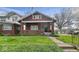 Charming craftsman-style home with a welcoming front porch and well-maintained lawn at 21 N Bosart Ave, Indianapolis, IN 46201