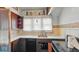 Compact kitchen featuring wood cabinets and vintage tile backsplash and countertop at 21 N Bosart Ave, Indianapolis, IN 46201