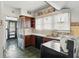 Compact kitchen with wood cabinets, laminate countertops, and vintage tile backsplash at 21 N Bosart Ave, Indianapolis, IN 46201